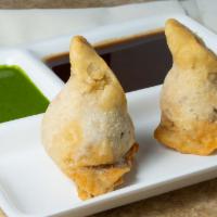 Samosa · Popular item. Two pieces. Fried appetizer filled with spiced potatoes, carrots, peas, and co...