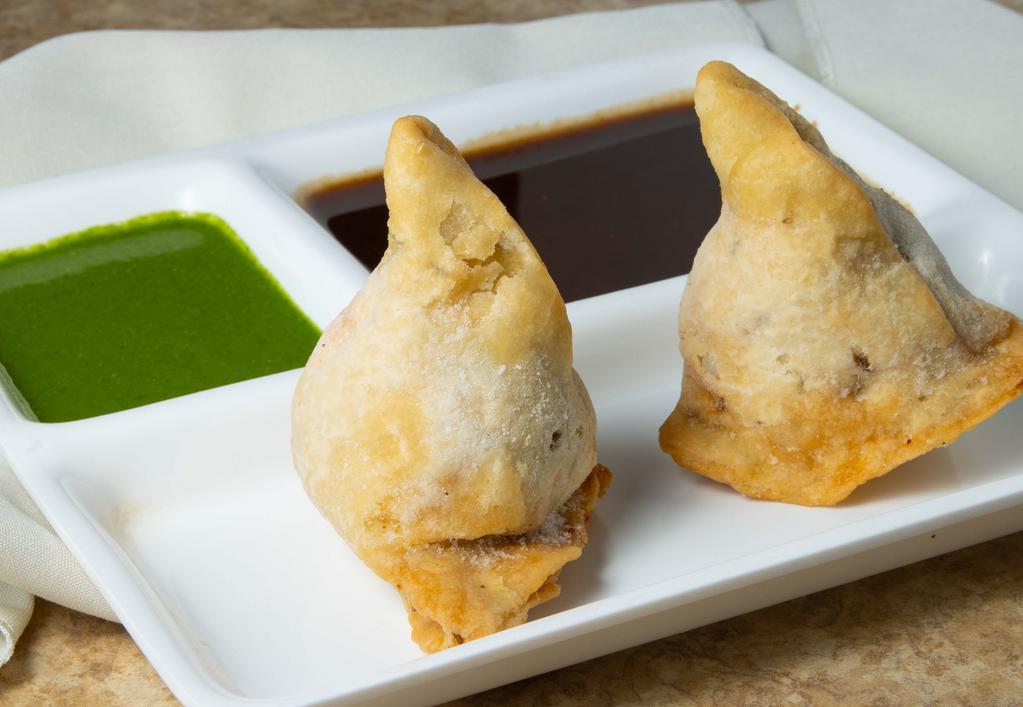 Samosa · Popular item. Two pieces. Fried appetizer filled with spiced potatoes, carrots, peas, and corn.