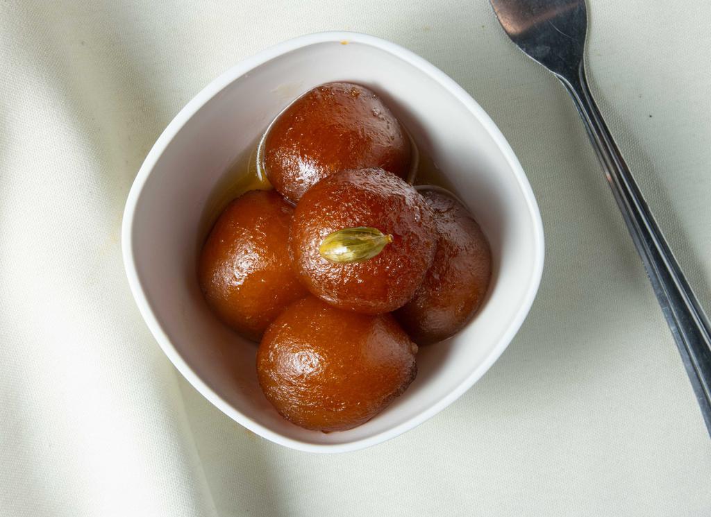 Gulab Jamun · One pound. A round dumpling made of thickened milk soaked in sugar syrup infused with saffron.