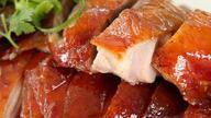 Peking Duck · A young seasoned duckling slowly grilled until crisp and golden, the delicate skins first shaved, then the meat is carved separately served with homemade crepes, spring onion, and hoisin sauce.