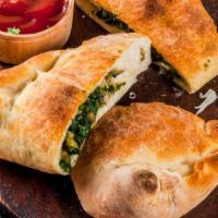 Spinach Roll · Locally grown spinach and creamy Mozzarella cheese filled in an oven-baked calzone.