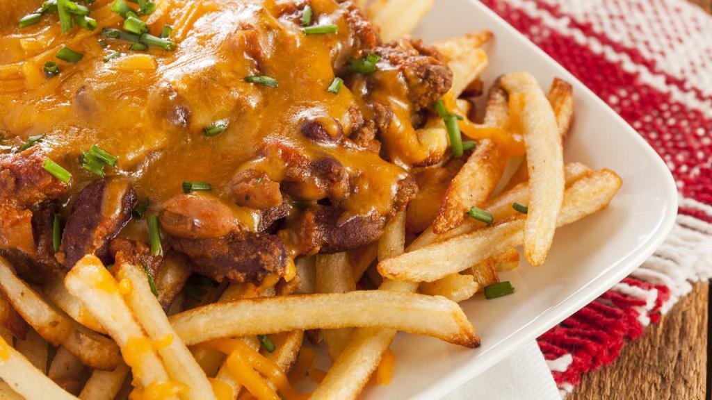 Chili Cheese Fries · Hearty chili and creamy cheese loaded onto golden French fries.