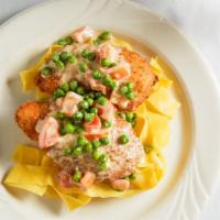 Chicken Reale · Breaded chicken, stuffed with ham and Fontina cheese, served in a cream sauce with fresh tom...