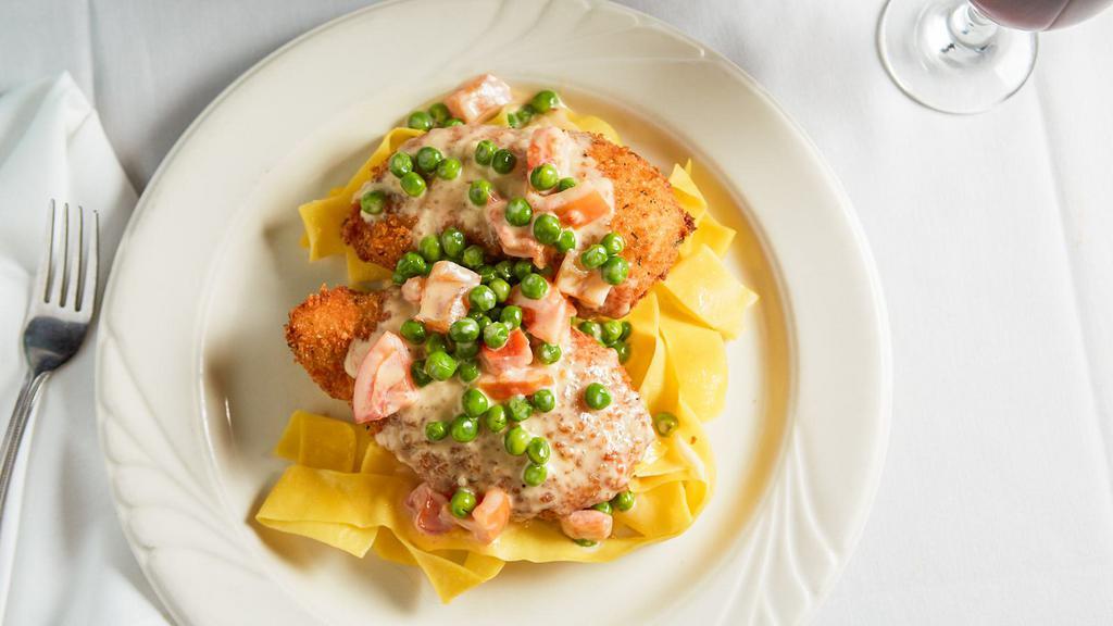 Chicken Reale · Breaded chicken, stuffed with ham and Fontina cheese, served in a cream sauce with fresh tomatoes and peas over pappardelle.