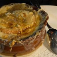 French Onion Soup · Caramelized onions and baguette toast smothered in melted gruyere.