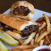 Philly Cheesesteak · Prime roast beef slices with grilled peppers, onions, mushrooms and melted American cheese.