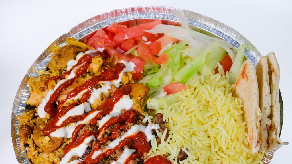 Chicken Over Rice · Chicken over Rice served on a platter with lettuce and tomatoes. Option of Hot Sauce, White Sauce and BBQ included.