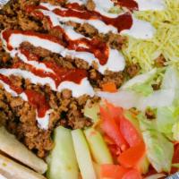Lamb Over Rice · Lamb over Rice served on a platter with lettuce and tomatoes. Option of Hot Sauce, White Sau...