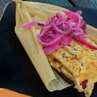 Tamales Cubano · homemade Cuban-style tamal, wrapped & steamed in a corn husk, pickled onions, romesco sauce ...