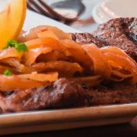 Bistec De Palomilla · seared thinly pounded sirloin steak, caramelized onions.