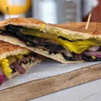 Veggie Cubano Sandwich · grilled portobello, grilled onion, Swiss cheese, pickles, truffled mojo.