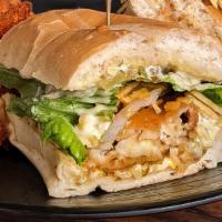 Old Hemingway Fish Sandwich · Fried fish fillet served on a Cuban bread roll topped with a tangy tarter sauce & raw onions...