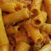 Rigatoni Alla Vodka · A pink creamy meat sauce simmered with vodka.
