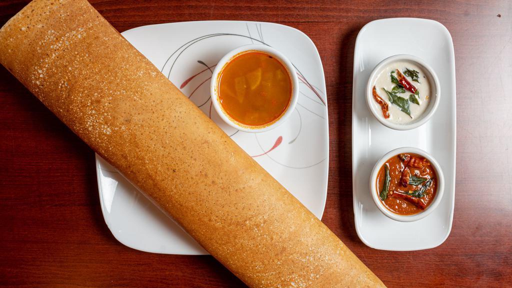 Masala Dosa · Crepe (made with rice and lentil dough) stuffed with potatoes, onions and nuts.