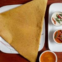 Spicy Pesarattu (Moong Dal Dosa) · Crepe made of cream of moong dal sprinkled with onion, chilies and ginger. Served with India...