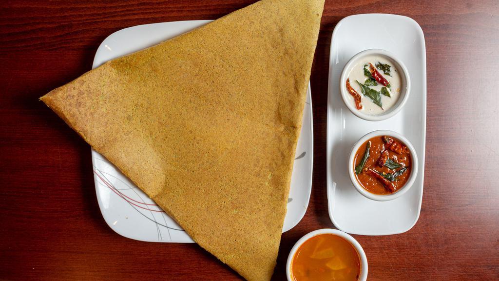 Spicy Pesarattu (Moong Dal Dosa) · Crepe made of cream of moong dal sprinkled with onion, chilies and ginger. Served with Indian sauces and soup.