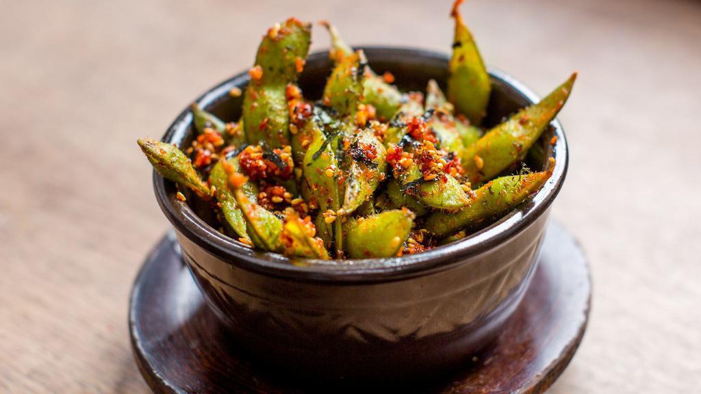 Edamame · Steamed edamame tossed in sea salt OR tossed in fried garlic, sesame chili oil, nori, and sesame seeds.
