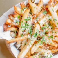 Truffle Fries · Ultimate crispy fries tossed with white truffle oil, 5 months aged Parmesan cheese, and pars...