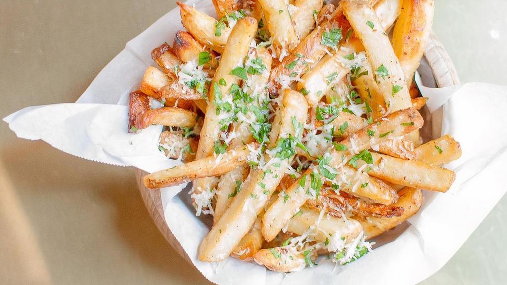 Truffle Fries · Ultimate crispy fries tossed with white truffle oil, 5 months aged Parmesan cheese, and parsley.