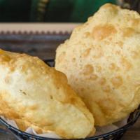 Poori · Deep fried puffed bread. Freshly prepared in our tandoor.