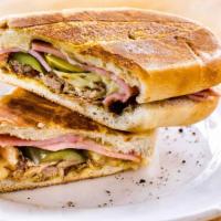 Cubano · Pressed Cuban sandwich with roast pork, ham, muenster cheese, pickles, mustard, and mayo.