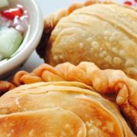 Curry Puffs · Flaky thai pastries filled with potato, onion and chicken in a thai curry seasoning. Served ...