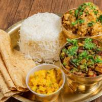 Homestyle Chicken Box · Dal, rice, chicken curry, rotis, aloo achar (pickle), salad.