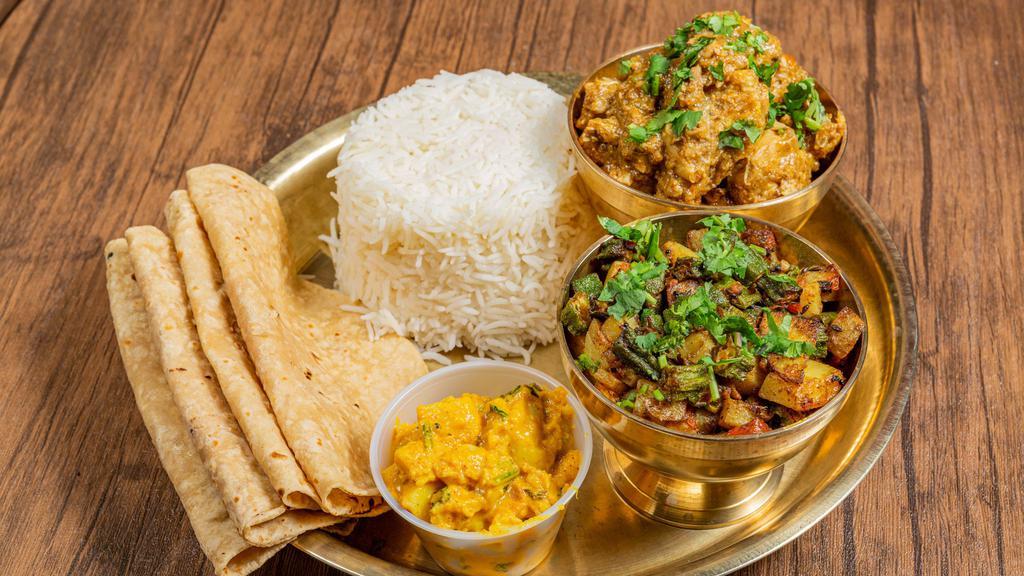 Homestyle Chicken Box · Dal, rice, chicken curry, rotis, aloo achar (pickle), salad.