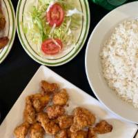 Combo 5 · Top menu item. Fried boneless chicken chunks with white rice, beans sweet plantains or salad...