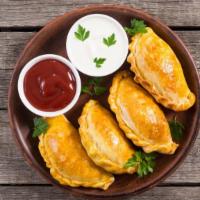 Empanadas · A pastry bread stuffed with your choice of chicken or beef.