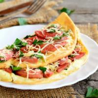 Western Omelette Platter · Fresh omelette prepared with scrambled eggs, Turkey, Ham, red & green peppers, onions and Am...