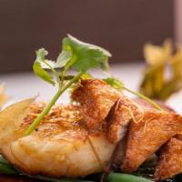 Chilean Xo Sea Bass · Grilled Chilean sea bass and fish cake with Asian XO seafood dressing.
