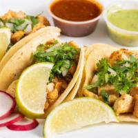 Chicken Tacos · Topped with pico de gallo, avocado and cebolla curtida choice of green, red or guacamole sau...