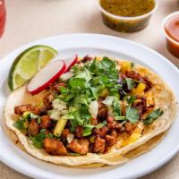 Al Pastor Tacos · Our Tacos are served on fresh soft corn tortilla, finished with freshly cut white onions and...
