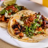 Spicy Pork Tacos · Our Tacos are served on fresh soft corn tortilla, finished with freshly cut white onions and...