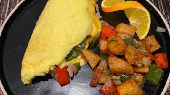 House Omelette · Bacon, ham, sausages, onions, peppers & American cheese.