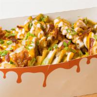 Loaded Fries · Crispy Golden Waffle Fries with Spicy Cheese Sauce, Bacon, Ranch, Scallion.