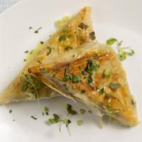 Spanakopita · Traditional spinach and feta triangles.