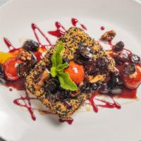 Sesame Feta · Pan seared sesame encrusted feta topped with candied figs, cherry tomato on a raspberry-hone...