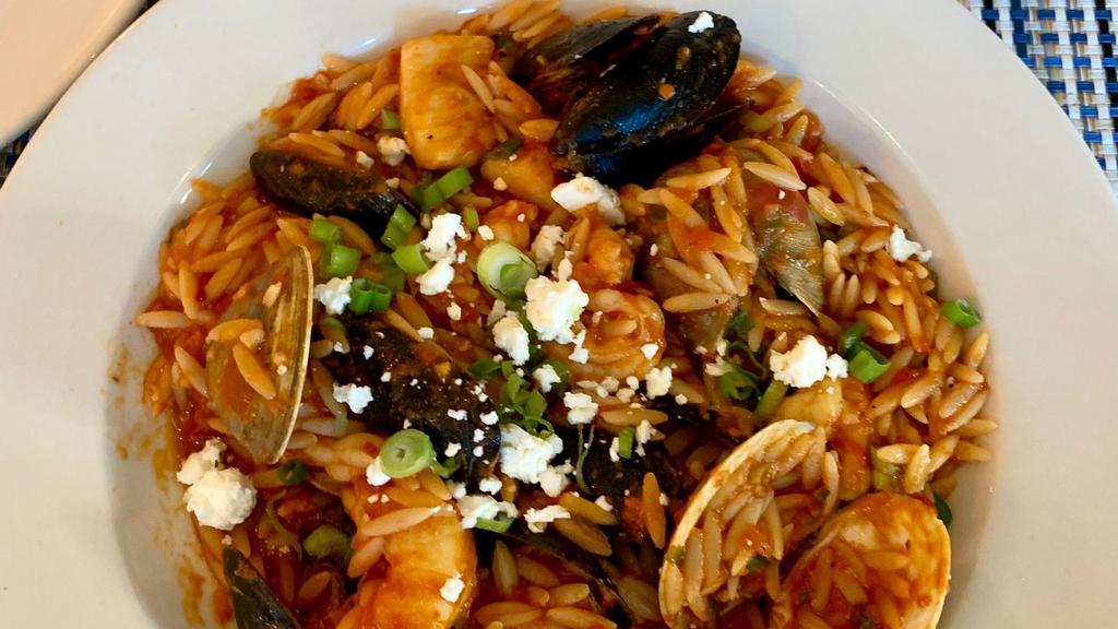 Seafood Orzo · Mussels, clams, shrimp, and squid in a creamy tomato sauce infused with herbs and ouzo.