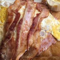 Lumberjack · Two eggs any style, two bacon, two ham and one sausage with pancakes or french toast.