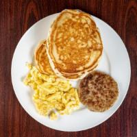 Pancakes Classic Breakfast · Three pieces of pancakes, two scrambled eggs, bacon or sausage.