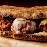 Buffalo Meatball Hero Sandwich · Delicious juicy buffalo marinated meatballs topped with our house sauce and toppings inside ...