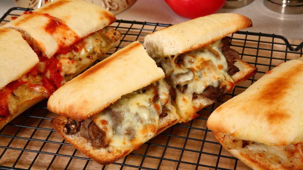 Sausage And Meatball Parm Hero Sandwich · Delicious juicy meatballs and sausage with parmigiana topped with our house sauce and toppings inside a soft delicious hero.