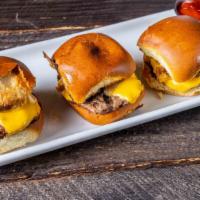 Sliders · Three mini hamburgers topped with cheese and sautéed onions.