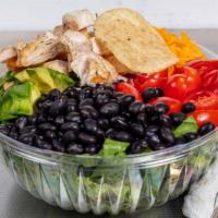 Mexican Salad · Mixture of crisp lettuce, black beans, grape tomatoes, red onion and avocado topped with che...