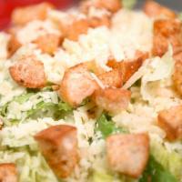 Caesar Salad · Crisp romaine hearts and aged parmesan topped with homemade croutons and tossed with homemad...