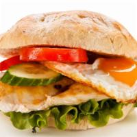 The Grilled Chicken, Egg & Cheese Sandwich · Toasted bread containing grilled chicken, egg and cheese with condiments.