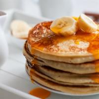 Banana Pancakes Platter · 2 fluffy banana buttermilk pancakes with choice of meat, eggs and cheese!.