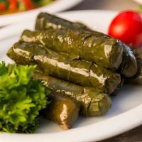 Stuffed Grape Leaves · Grape leaves stuffed with a mix of rice, onions, tomatoes, parsley, and spices.